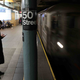 A commuter holds a cell phone on the platform for the 50th St. station on the 1 line in the NYCT subway.